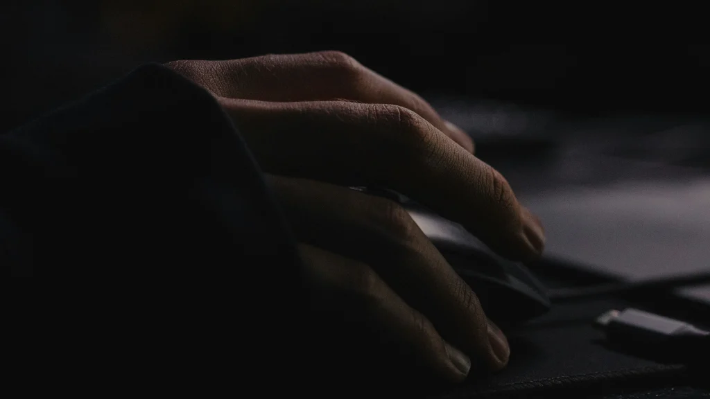 A person's hand on a book - HD photo of computer, hand, mouse, and gamer.